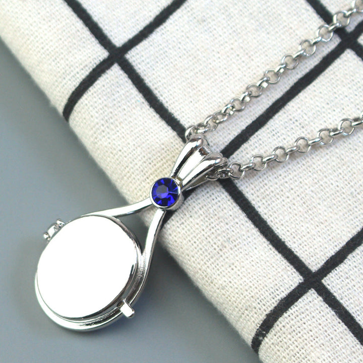 Magnetic flip-top shell necklace with diamond-encrusted mermaid design